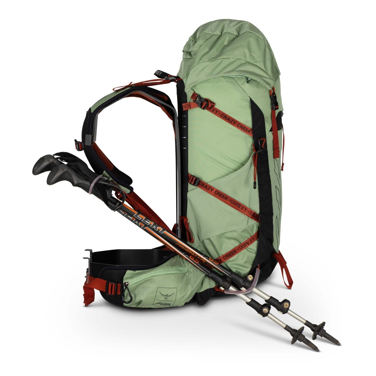 A green hiking backpack with adjustable straps and trekking poles secured to its side, designed for outdoor adventures.