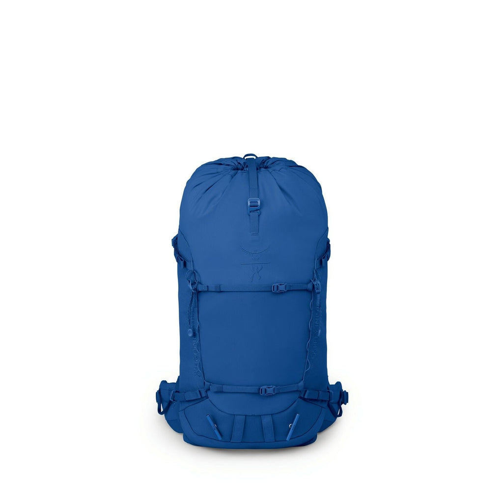 The image features a backpack that appears to be designed for hiking or outdoor activities, prominently displayed against a white background. It is entirely blue in color, showcasing a sleek and streamlined design with minimalistic features. The backpack