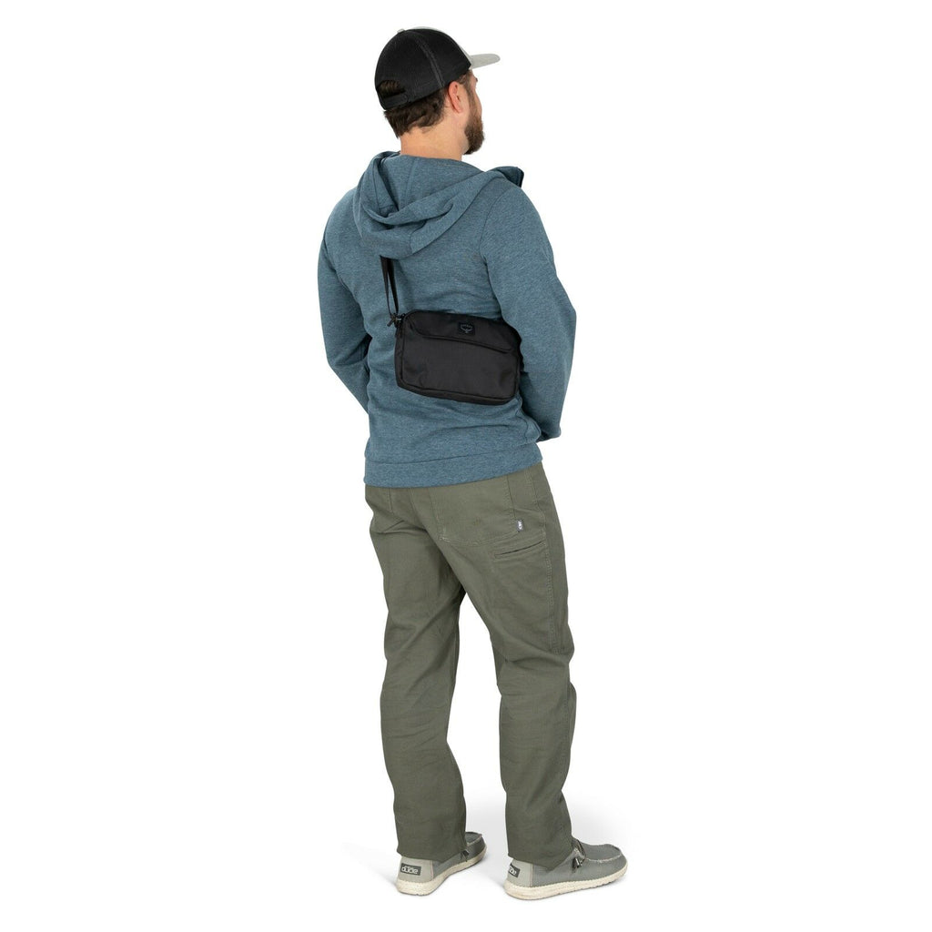 a person modeling the Aoede Crossbody Bag  in color Black