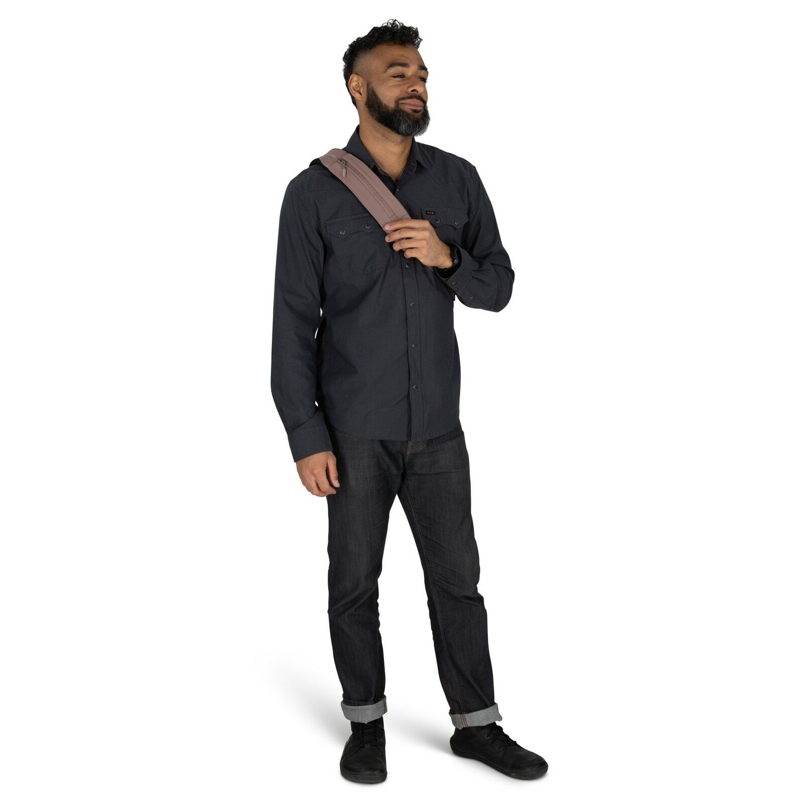The image shows a man standing in two different poses, showcasing both the front and back view of his outfit. He is dressed in a casual yet stylish manner, wearing a dark button-up shirt paired with dark jeans that are cuffed at the bottom. His footwear c