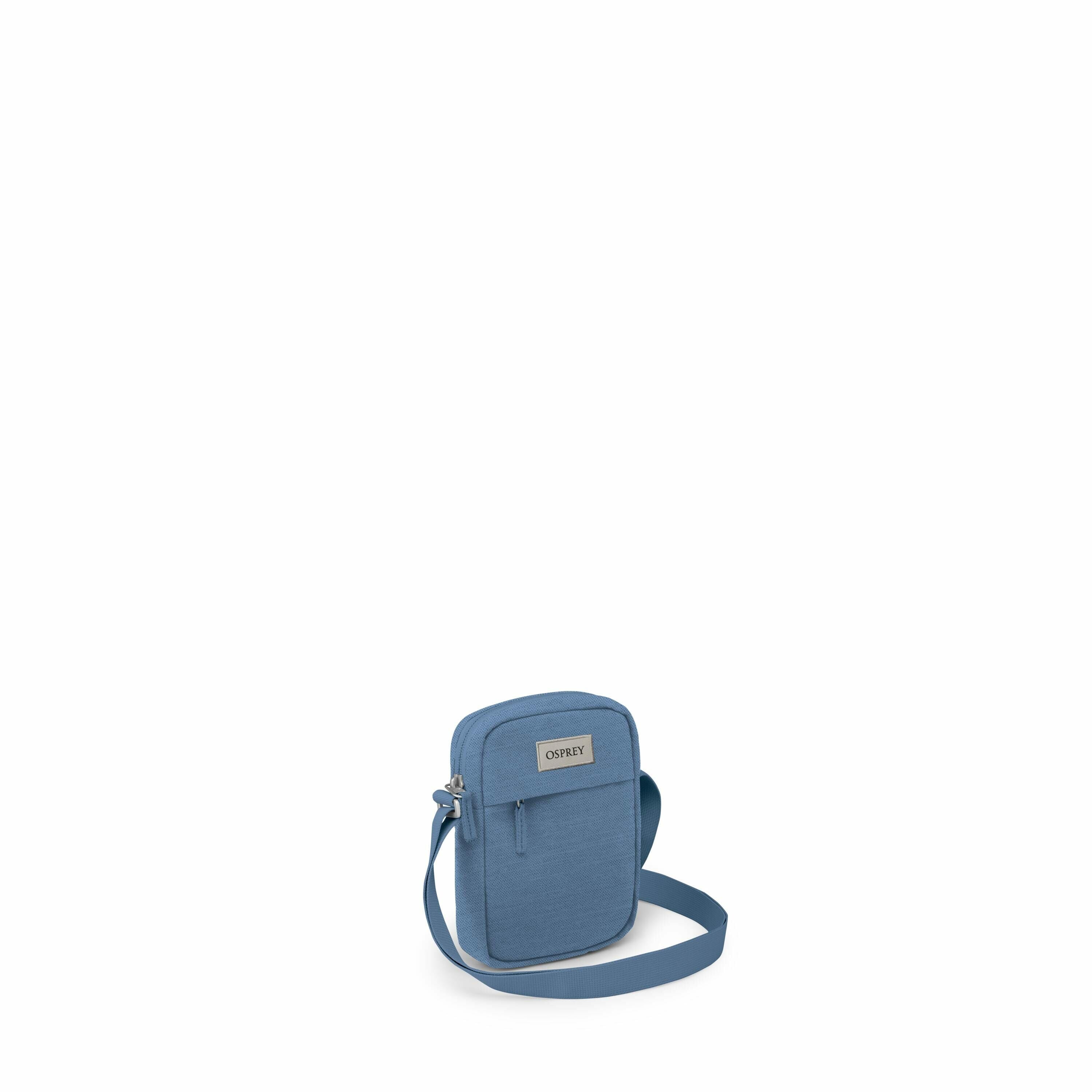 The image displays a series of blue Osprey bags arranged to show various parts and angles of the bag. The main focus is on a compact, rectangular crossbody bag with a prominent Osprey logo on its front. The bag features a front zippered pocket and an adju