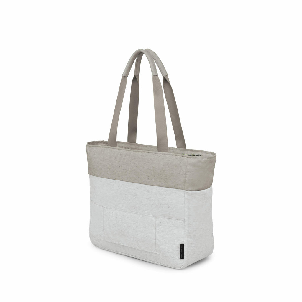 The image depicts a light grey tote bag with a two-tone design featuring a darker grey section at the top and lighter grey at the bottom. The bag has two long straps for easy carrying over the shoulder or in hand. A set of images shows the tote bag in var