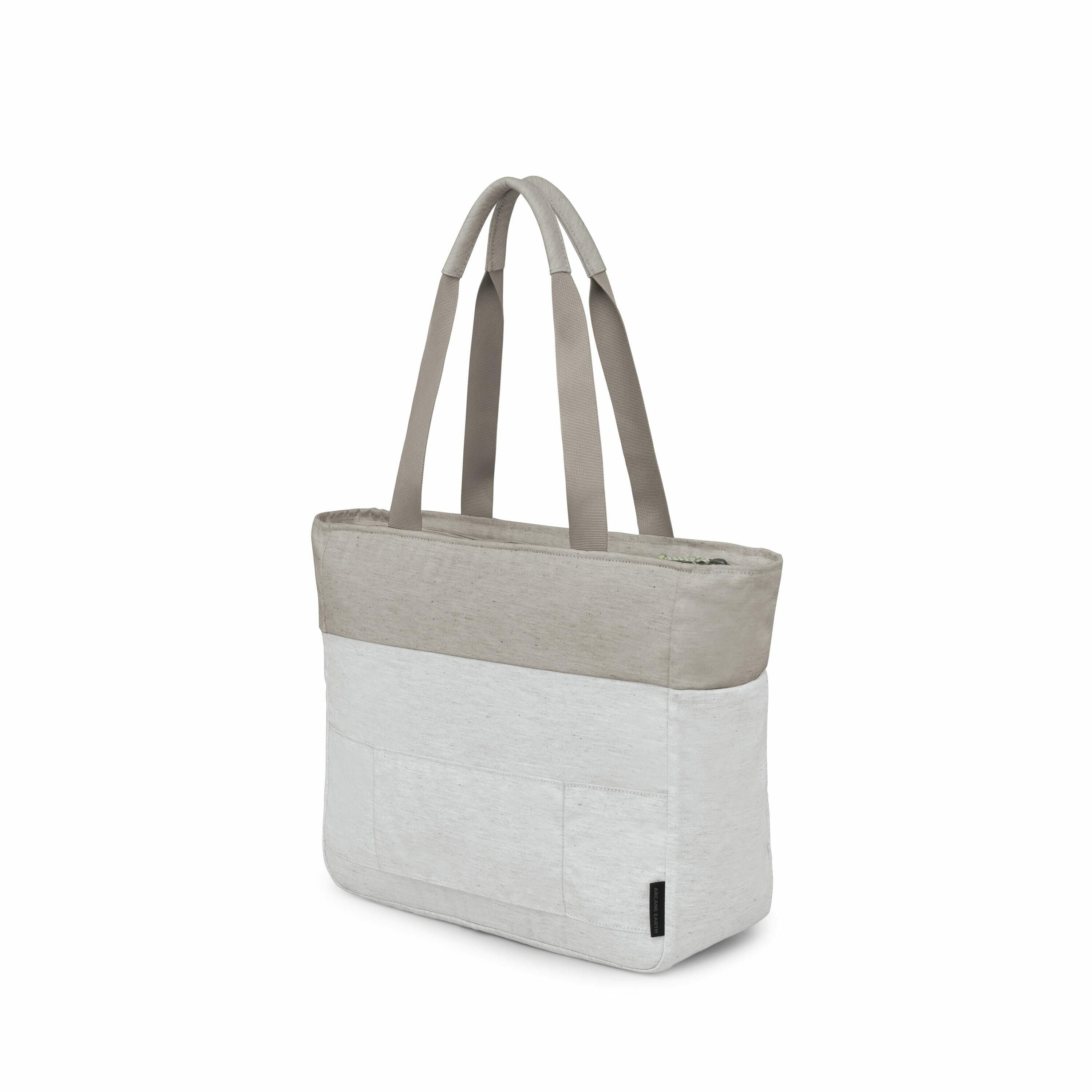 The image depicts a light grey tote bag with a two-tone design featuring a darker grey section at the top and lighter grey at the bottom. The bag has two long straps for easy carrying over the shoulder or in hand. A set of images shows the tote bag in var