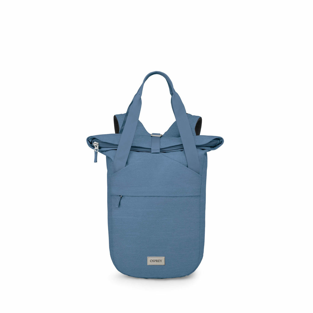 The image shows a blue backpack made by Osprey, designed in a unique roll-top style. It features a large main compartment secured by a zipper and buckle, providing easy access and extra security. The backpack has sturdy carrying handles and a front zipper