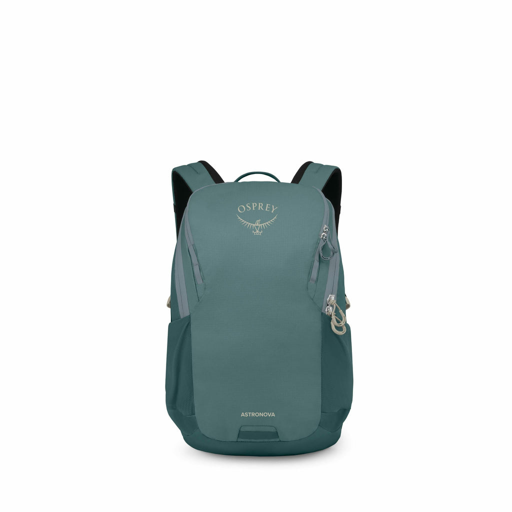 The image showcases an Osprey backpack named "Astronova" in a shade of teal. It appears to be a sleek and compact design suitable for everyday use or short trips. The backpack features the Osprey logo prominently on its front and has multiple zippers and