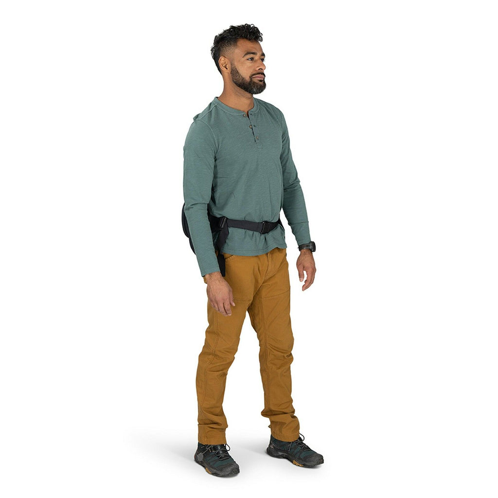 View of male model wearing Osprey Photo Lid in the color Black. View is of the hipbelt from the front