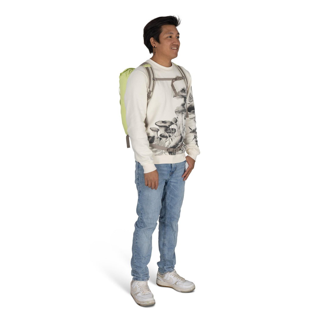 The image shows a person standing and wearing a casual outfit. They have on a white sweatshirt with a detailed black-and-white mushroom print design. The person is also wearing light blue jeans and white sneakers, creating a relaxed and comfortable look.