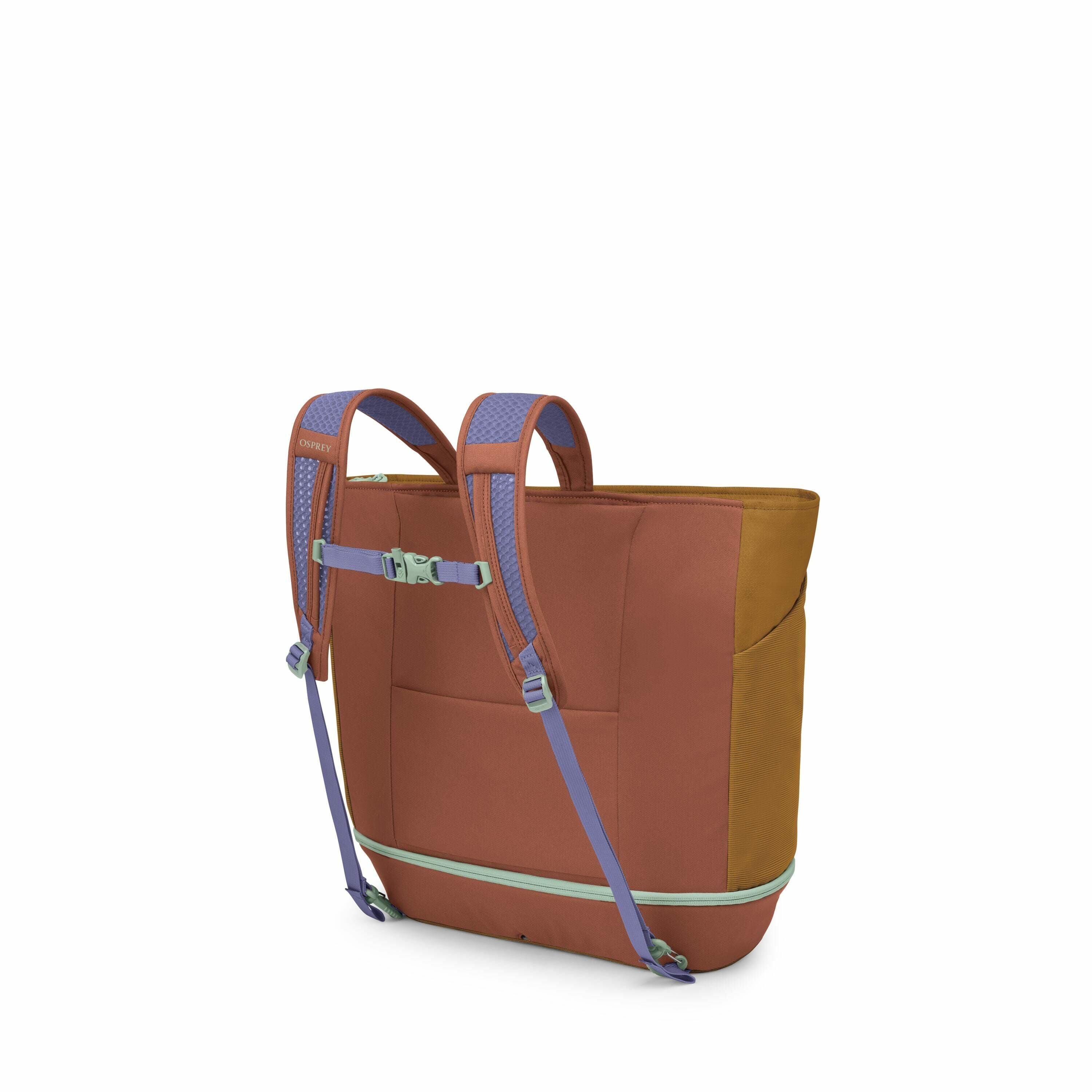 The image shows a colorful backpack from a rear angle, highlighting its design and functionality. The backpack features a combination of earthy brown and mustard colors for its main body, with lilac-colored shoulder straps that include light blue padding