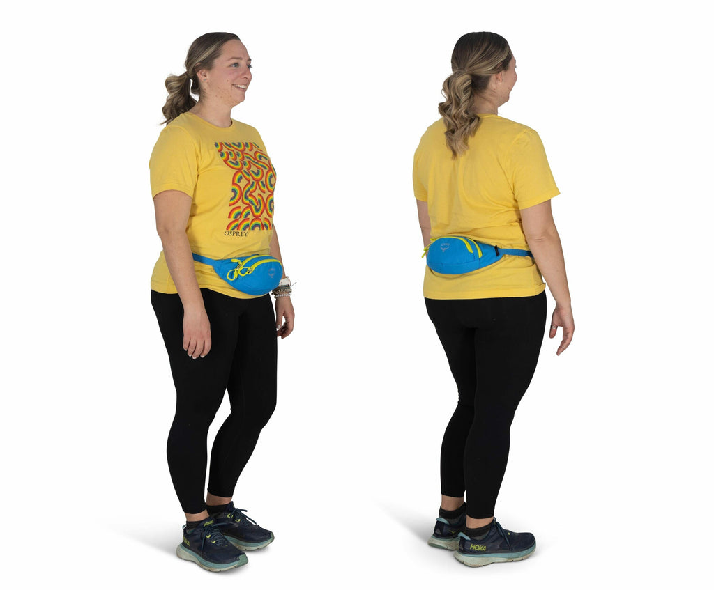 The image shows a person standing in two poses: one facing forward and the other facing backward. The individual is wearing a bright yellow t-shirt with a colorful abstract design on the front, black leggings, and a pair of athletic shoes with dark colors