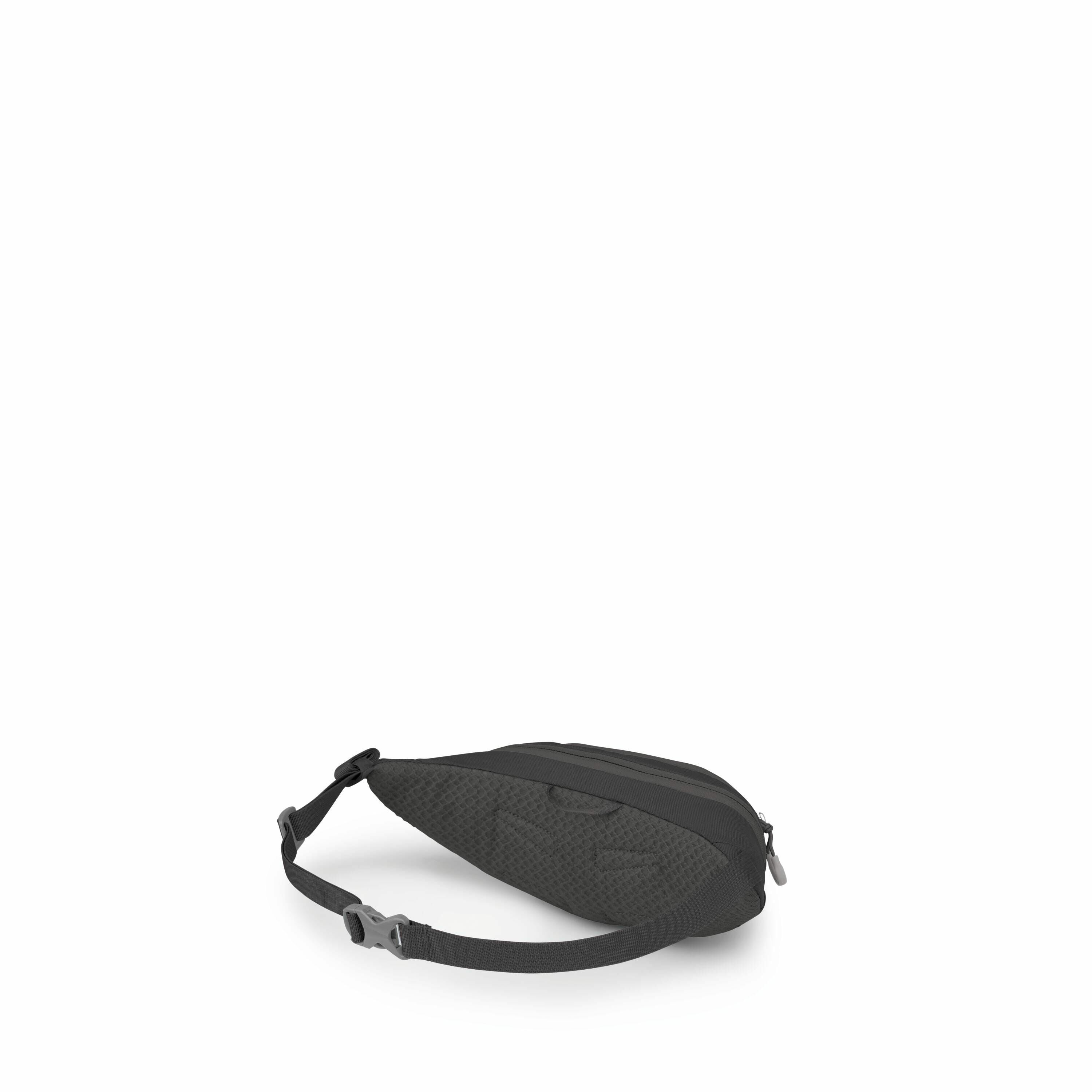 The image showcases a compact black sling bag, designed for easy wear around the waist or across the body. The bag features a textured pattern, adding a stylish element to its otherwise minimalist design. It has a zippered main compartment, and the adjust