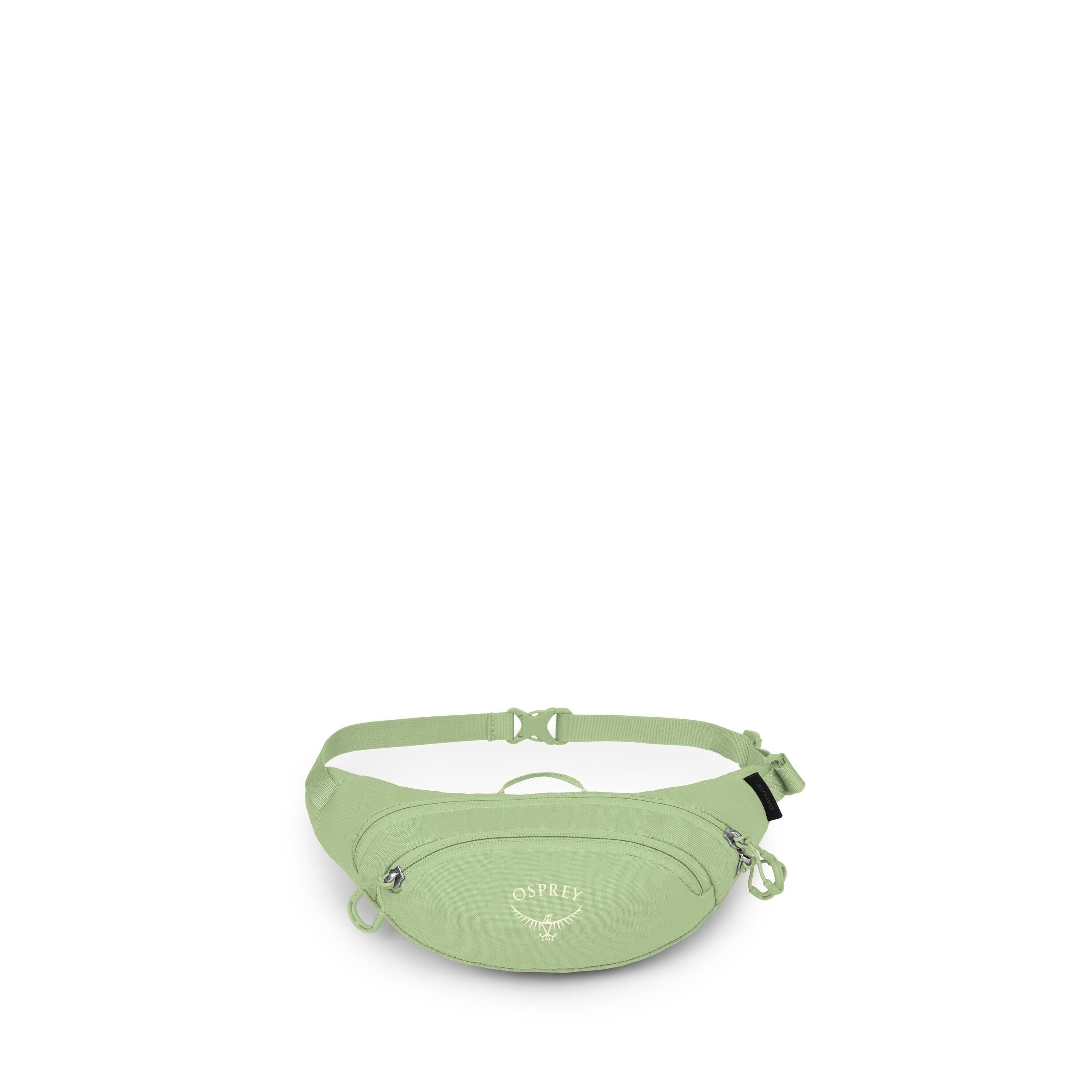 The image shows a light green Osprey waist pack, also known as a fanny pack, on a white background. It has an adjustable strap with a side-release buckle and a small top grab handle. The front features a zippered pocket with two zipper pulls and the white
