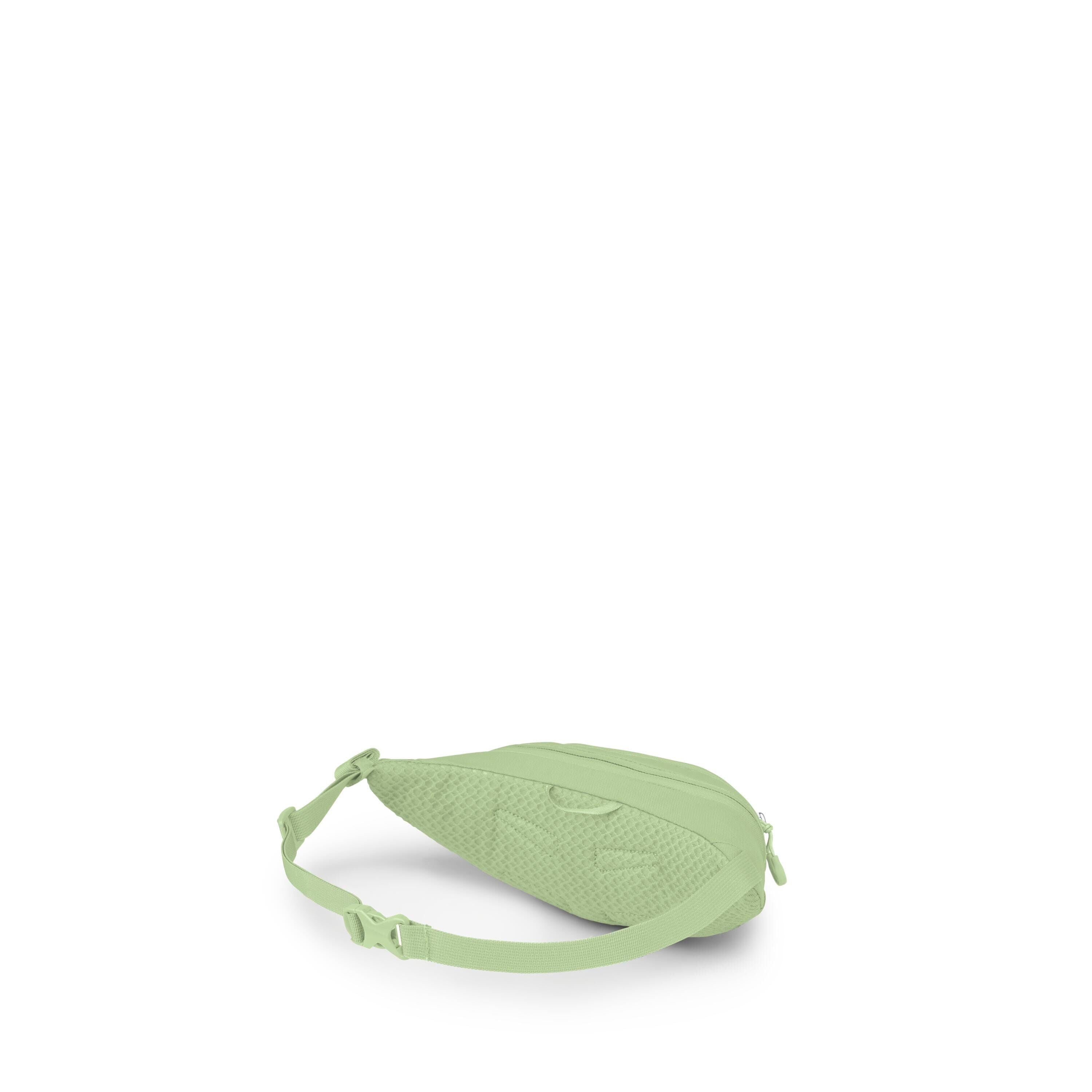 A small light-green sling or waist bag is shown on a white background. It has a teardrop shape with a zippered main compartment and an adjustable strap with a plastic buckle. The back panel appears padded with a textured, breathable fabric for comfort. Th