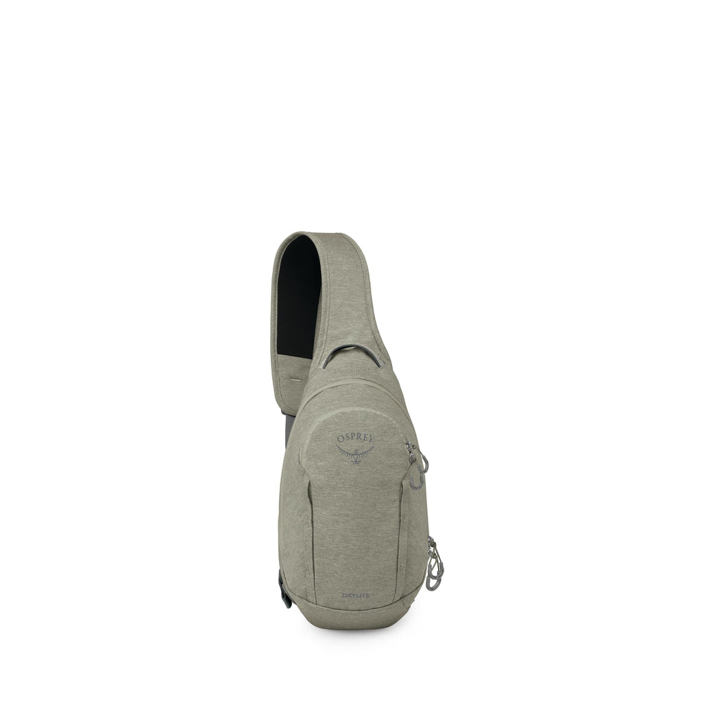 The images show a compact sling-style backpack in a muted sage green color. It has a single, wide shoulder strap, a small top grab handle, and a teardrop-shaped main body. The front features a zippered pocket with the Osprey logo and "Daylite" text, plus