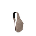 The image shows a compact, tan-colored sling bag with a single padded shoulder strap. Its teardrop-shaped body has multiple zippered compartments and subtle seam detailing. The front features an Osprey logo patch and the word "Daylite" near the bottom. Th