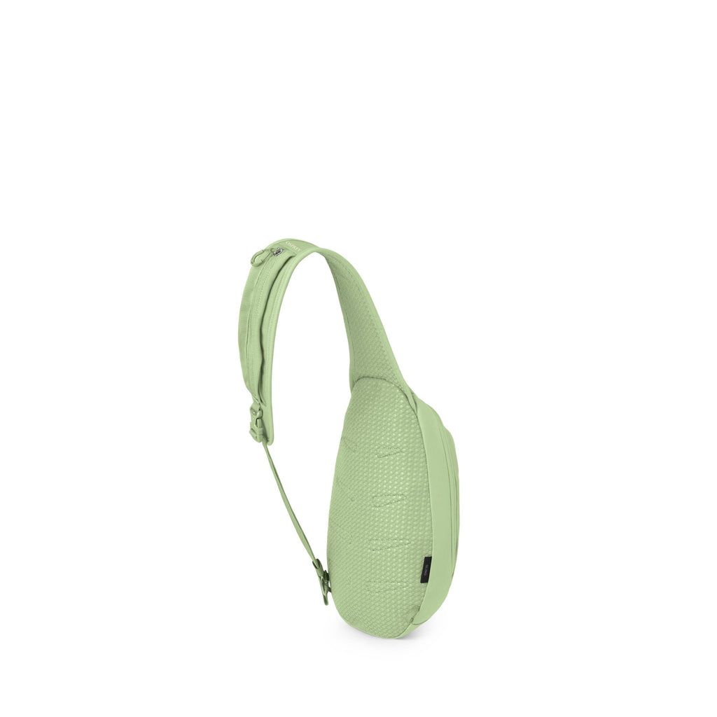 The image shows a compact sling backpack with a teardrop-shaped body. It has a single padded shoulder strap in green that curves over the top and connects to an adjustable green webbing strap. The back panel is black and appears cushioned for comfort. The