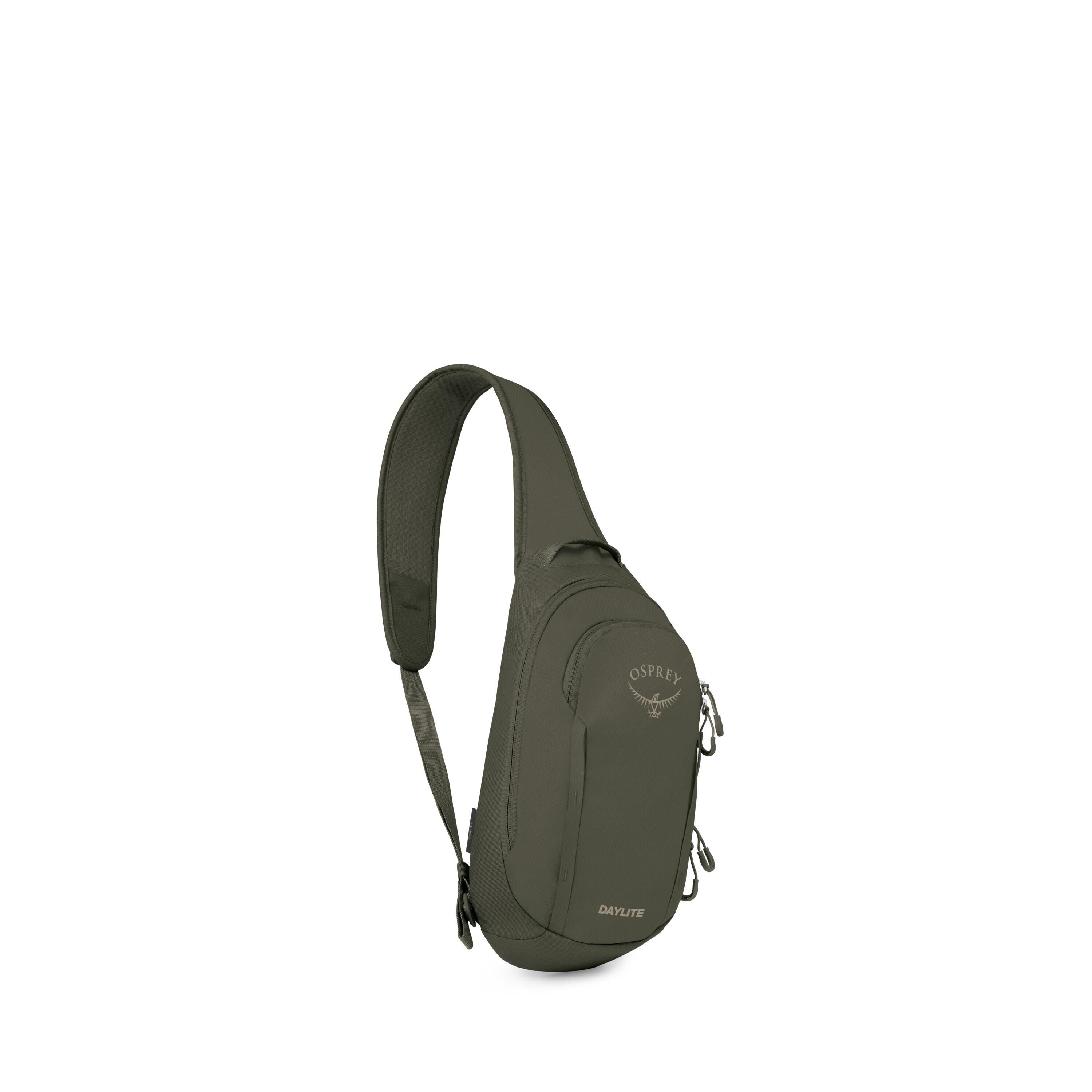 A dark green Osprey Daylite sling bag is shown against a white background. The compact pack has a single, wide shoulder strap designed to be worn cross-body. It features two zippered compartments with matching green zipper pulls and a small top grab handl