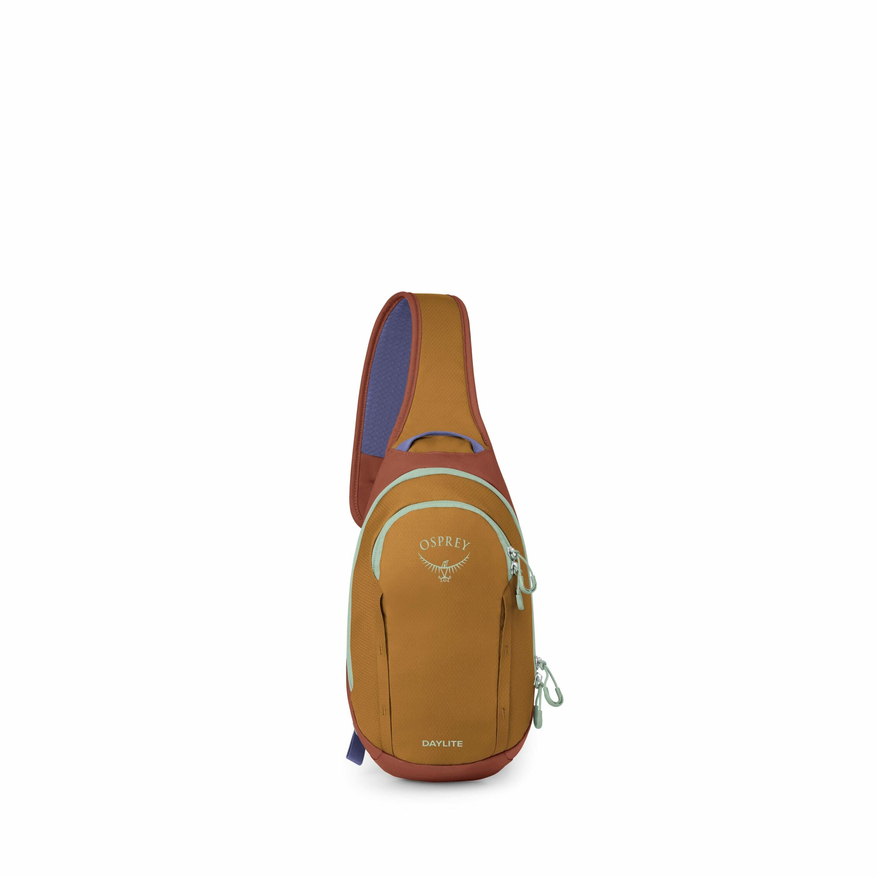 The image features an Osprey Daylite sling bag designed for casual and day use. This bag has a teardrop shape with a single shoulder strap, highlighting its ergonomic design intended for comfortable carrying. The front of the bag is a warm brown color wit