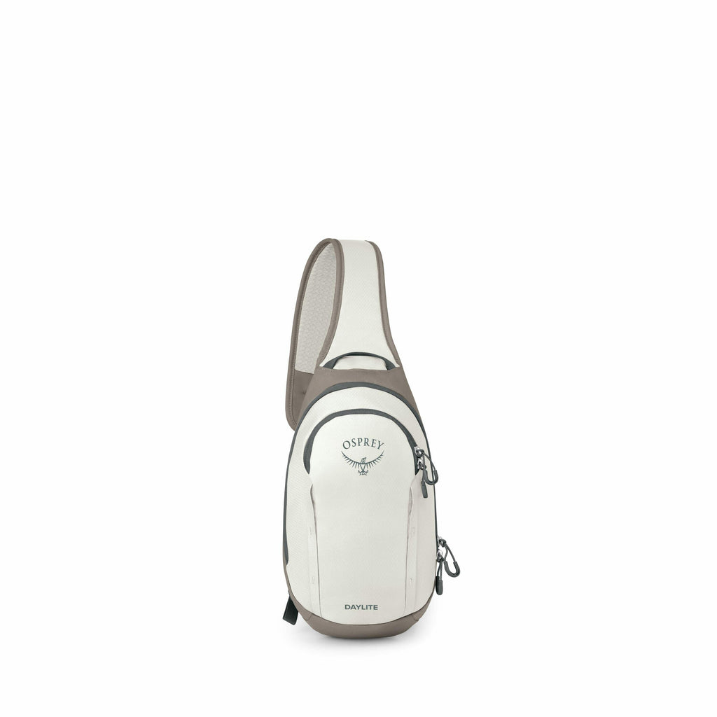 The image shows an Osprey Daylite Sling backpack, prominently displayed against a white background. The backpack is primarily a light cream color with darker accents, including a brown or gray strap and bottom. It has the Osprey logo and text printed on t