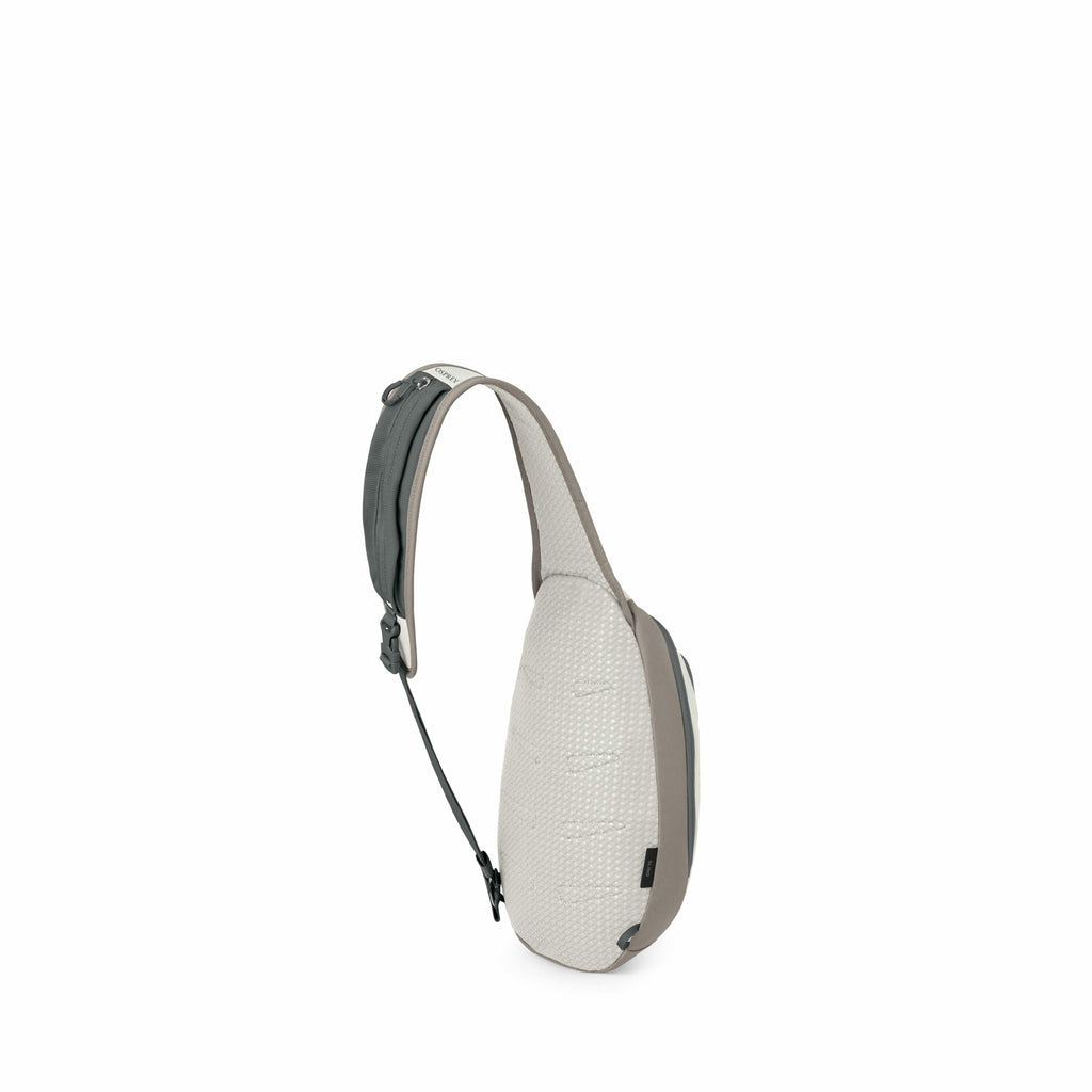 The image showcases a sling bag designed for convenient carry. It features a sleek and minimalist design with a single adjustable strap that allows it to be worn comfortably across the body. The bag's color palette includes shades of grey and off-white, w
