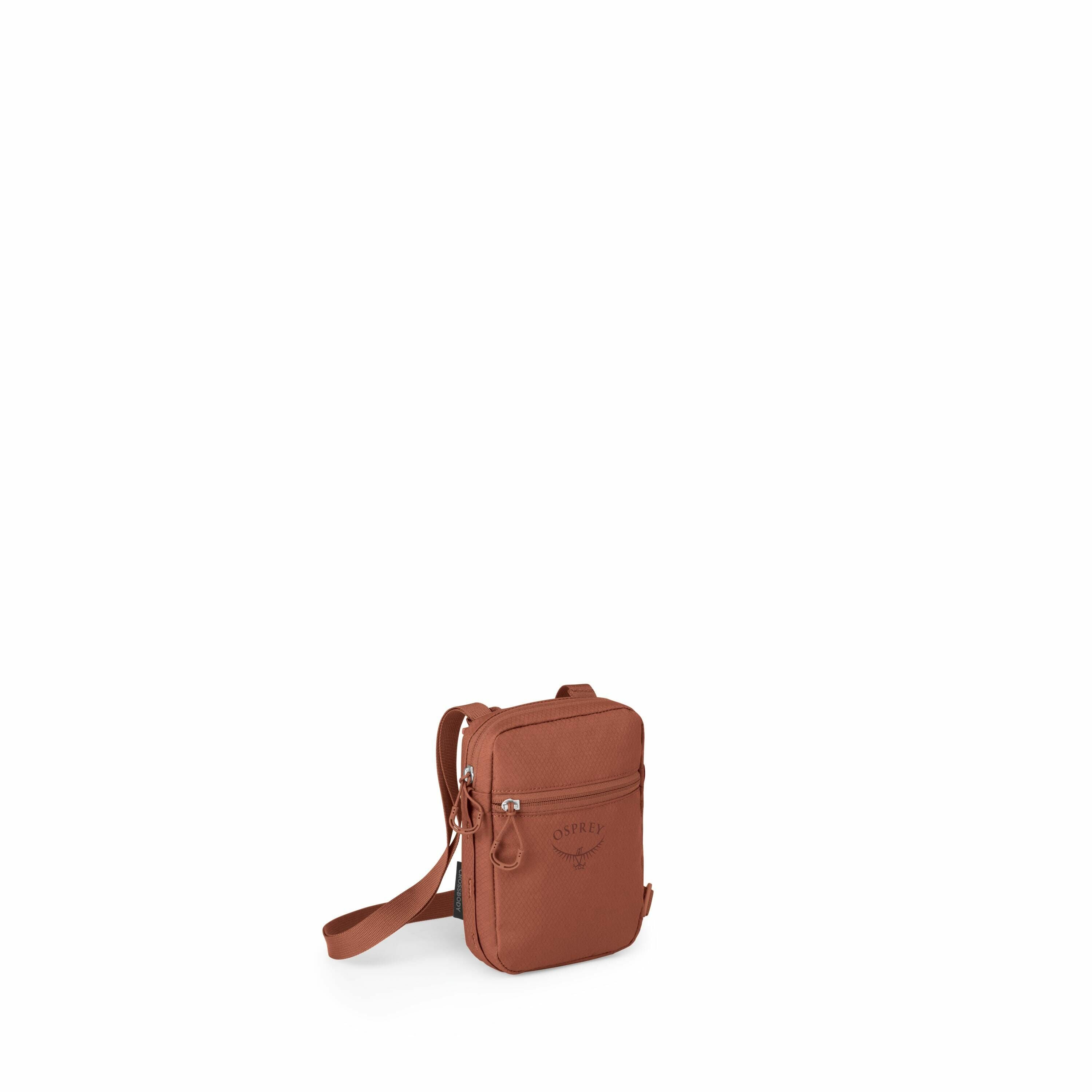 The image shows a compact, rectangular crossbody bag by Osprey, made in a rich, earthy brown color. The bag features a front zip pocket with the Osprey logo prominently displayed, showcasing their signature bird emblem and branding. It has a simple yet fu