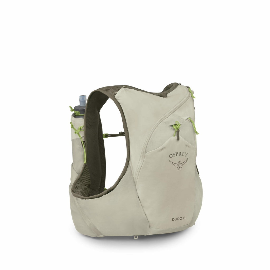 The image depicts a beige Osprey Duro 6 hydration vest, designed for runners or hikers. The vest features multiple pockets and compartments, with a hydration flask visible in one of the pockets, indicating its purpose for carrying fluids on the go. The de