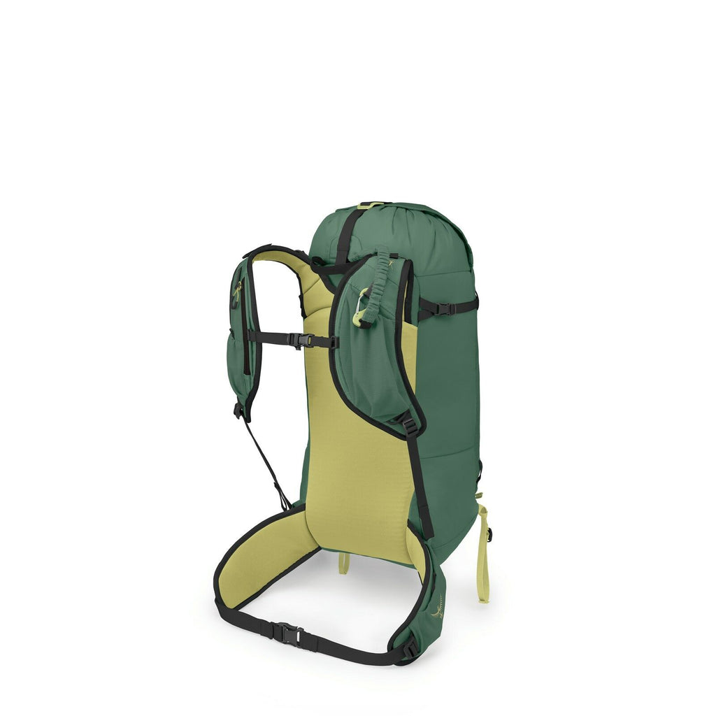 The image showcases a green hiking backpack with a streamlined and minimalist design. It features an olive green main body with dark green and black accents, including the straps and buckles. The backpack has a light tan back panel and shoulder straps for