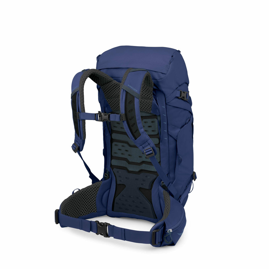 The image shows a blue backpack with a highly structured and ergonomic design, viewed from an angle that highlights its padded back panel and adjustable straps. The backpack has multiple components including a top flap, various pockets, and several adjust