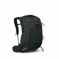 The image displays a black Osprey backpack with a sleek design, showcasing multiple compartments and straps for versatile use. The brand's logo, featuring the Osprey name and emblem, is prominently displayed on the top flap of the backpack. It is equipped