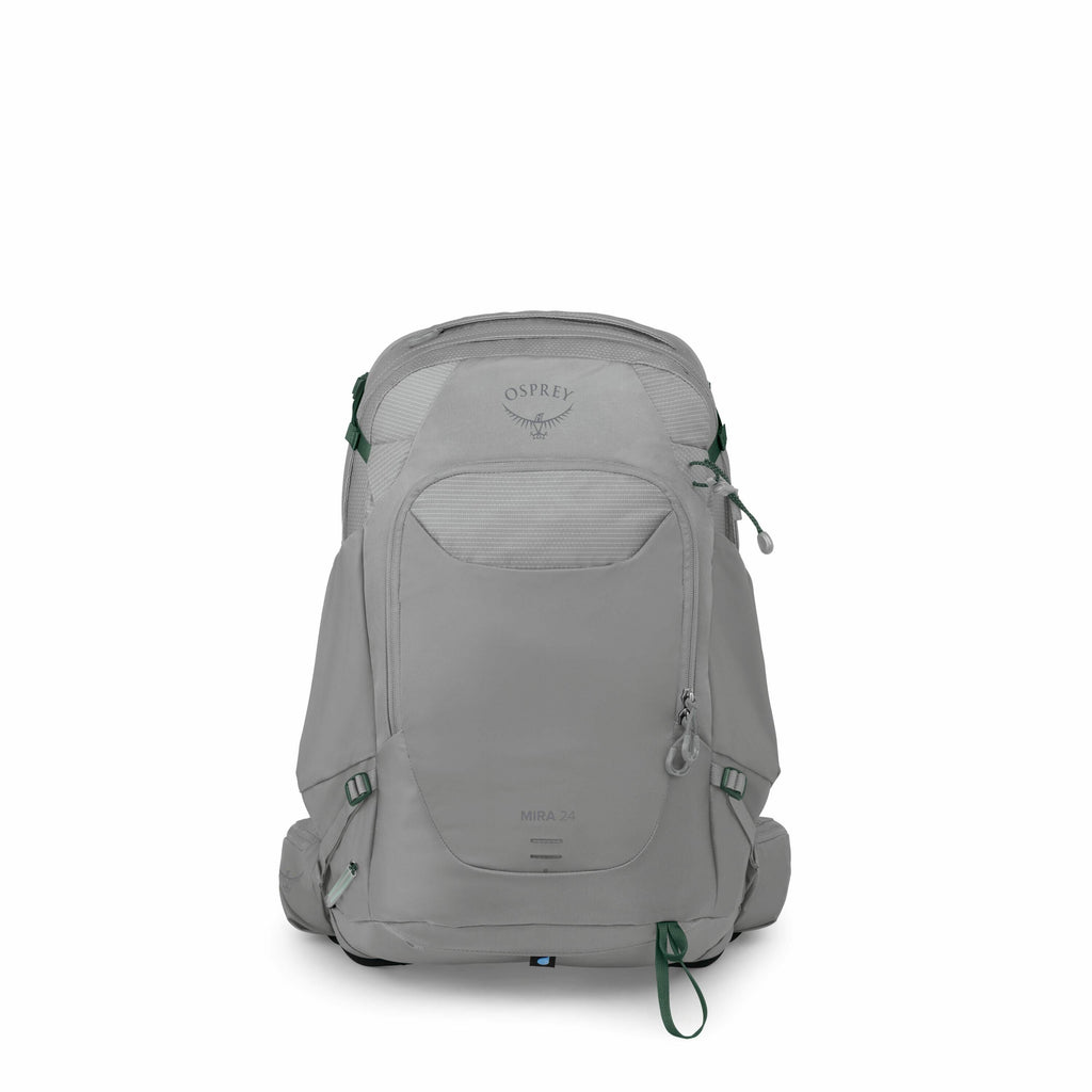 The image displays a grey Osprey backpack with a sleek design, featuring multiple compartments and green accents on its straps and zippers. The Osprey logo is prominently visible on the top section of the backpack, just above a mesh pocket. The backpack,