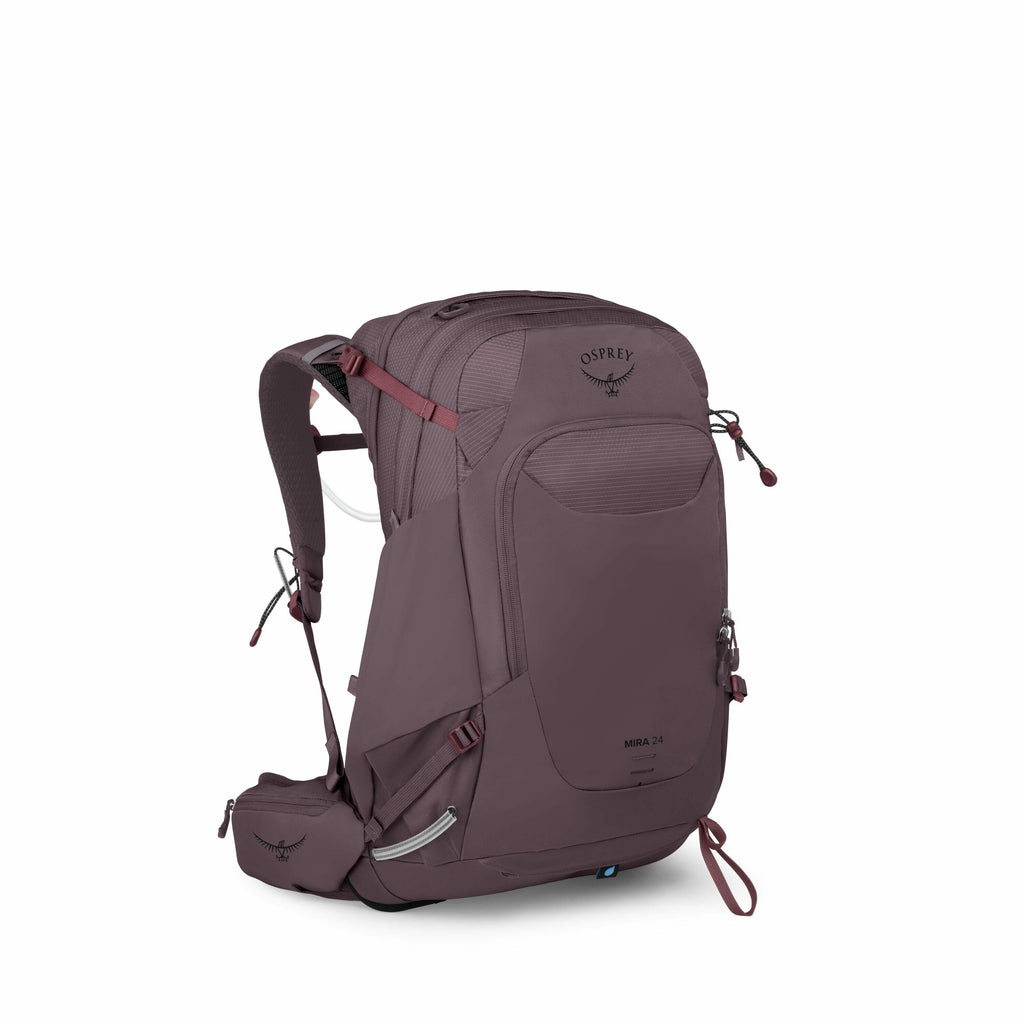 The image showcases an Osprey Mira 24 backpack, designed for outdoor activities such as hiking or trekking. The backpack is a muted purple color with darker shades on the shoulder straps and back padding. The design features multiple compartments with zip