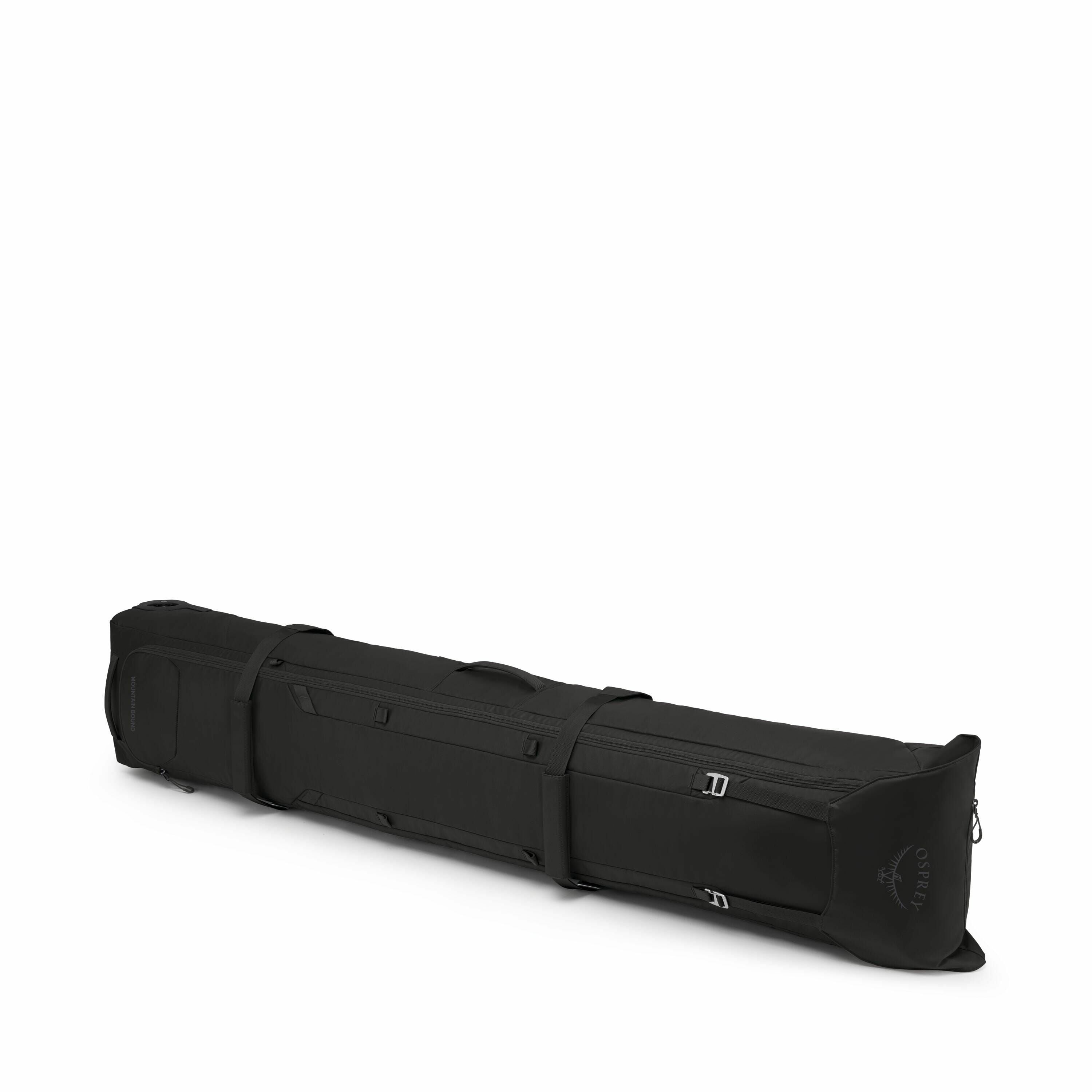 The images showcase a large, elongated black bag designed for carrying long items, such as skis or snowboards. The bag features a padded construction for protection and has buckles and straps for securing its contents. A logo can be seen on one end of the