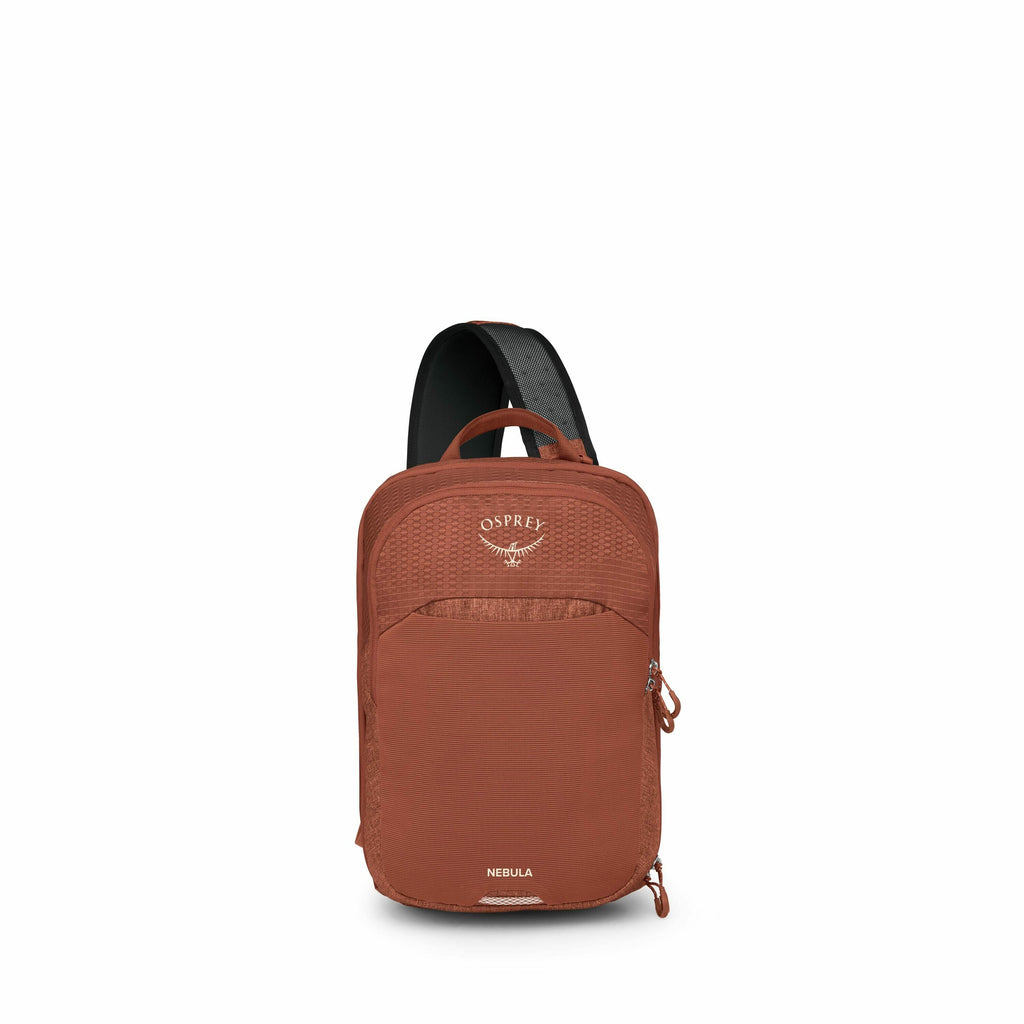 The image showcases an Osprey Nebula sling backpack in a rich, rust-orange color. The backpack features a single over-the-shoulder strap and is compact in design, making it ideal for light travels or daily errands. The Osprey logo, an abstract representat