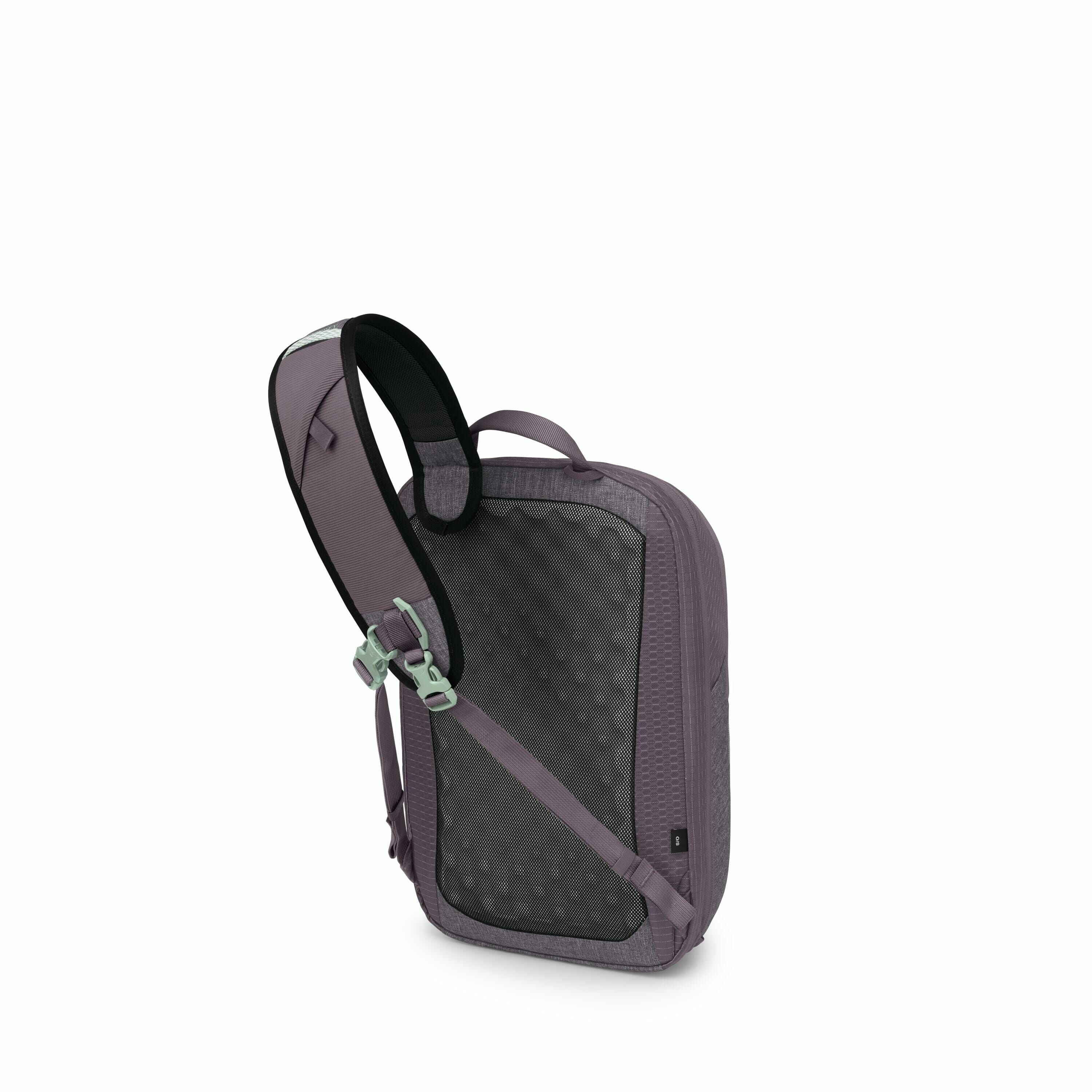 The image displays a sleek and modern sling backpack with a subtle purple color. The backpack has a single adjustable strap, equipped with a mint green buckle for secure closure. Its rear features a textured mesh padding, designed for comfort against the