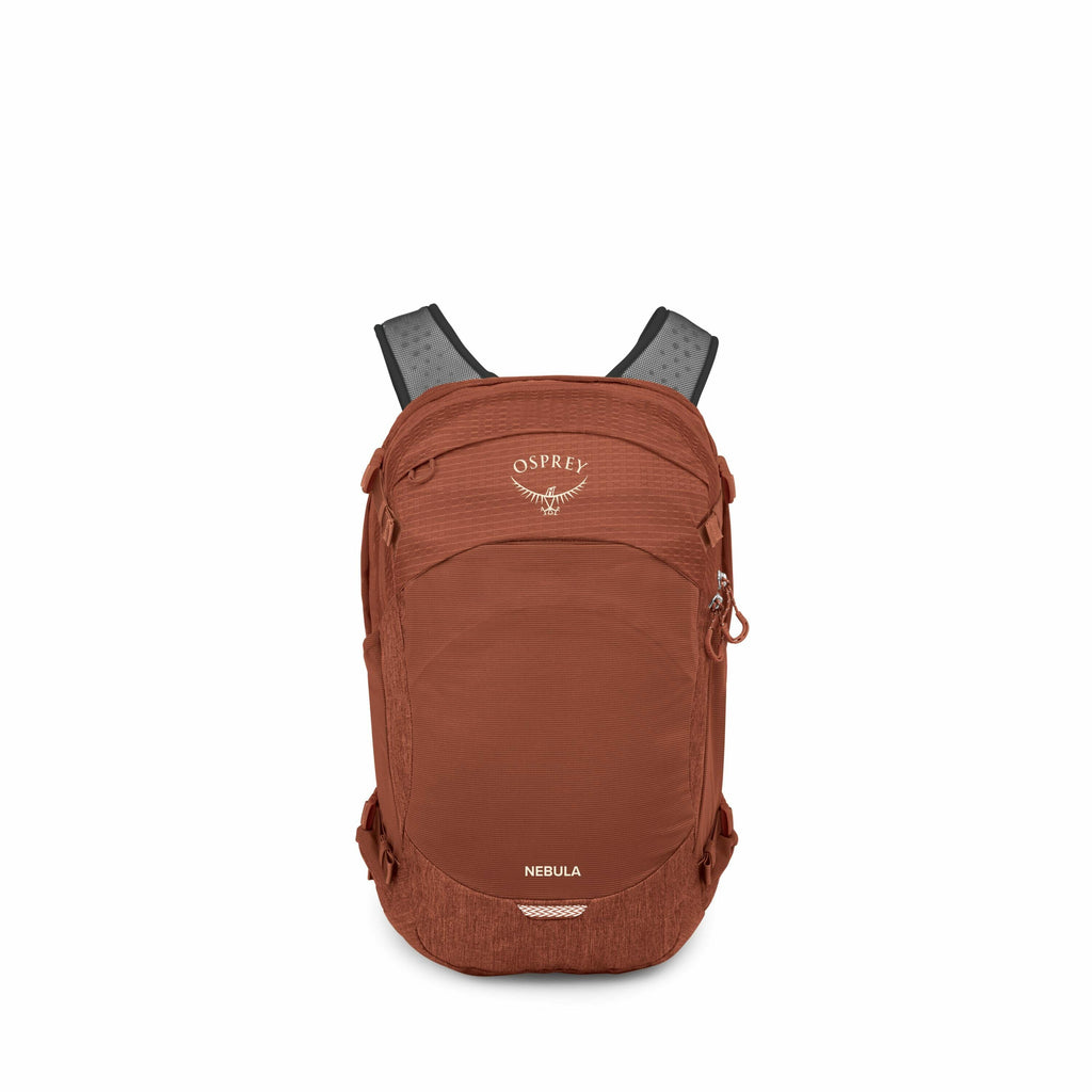 The image shows an Osprey Nebula backpack in a rust-colored shade. The backpack is displayed against a plain white background, emphasizing its design and features. The Osprey logo, a stylized bird emblem with the word "Osprey" above it, is prominently fea