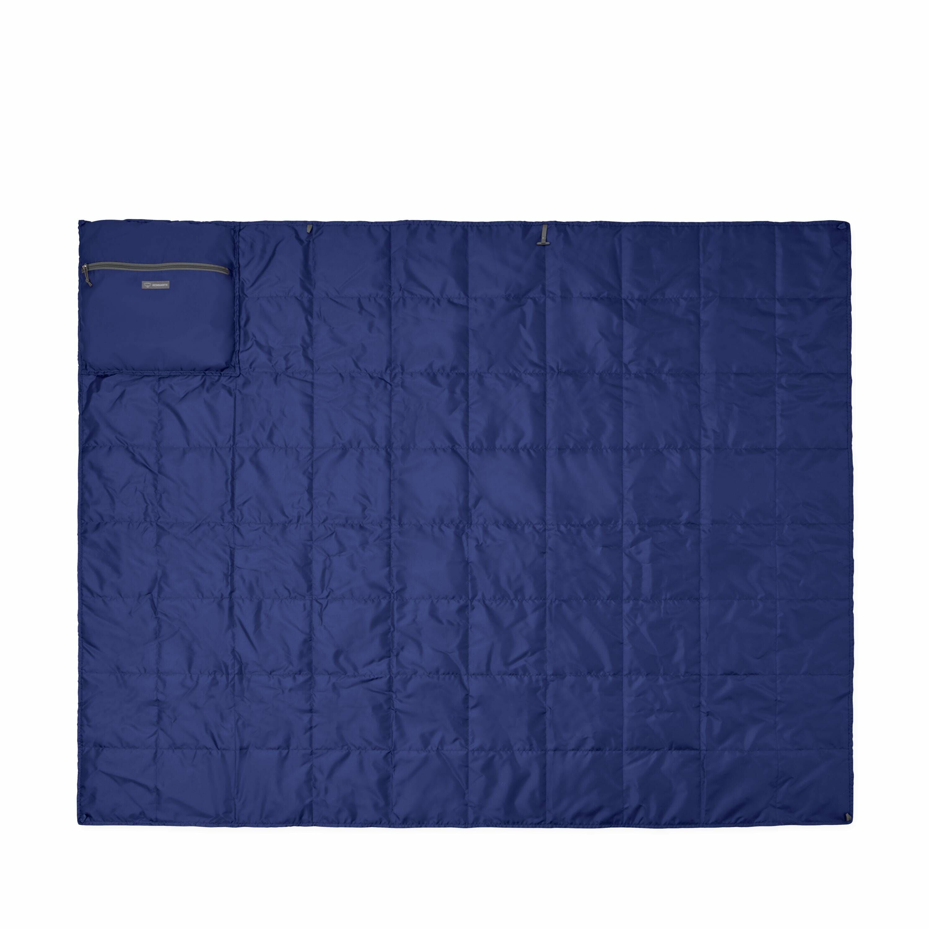 The image showcases a blue quilted blanket laid out flat, with a pocket or pouch situated in the top left corner. The blanket appears to have a smooth, shiny texture, likely made from a synthetic material such as nylon or polyester, providing a lightweigh