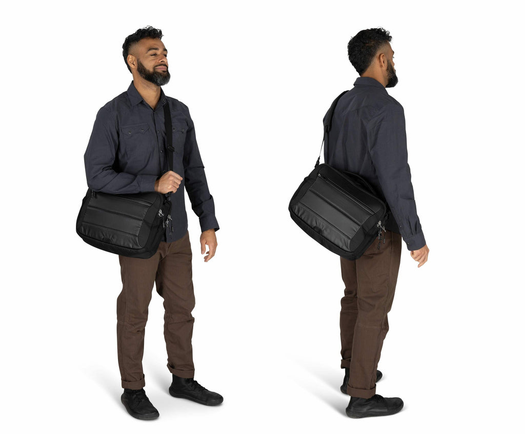 The image depicts a man standing and holding a black shoulder bag, shown from two angles: front and side. He is wearing a dark long-sleeve shirt, brown pants, and black shoes. The bag, likely made from a durable fabric, has a sleek design with zippers vis