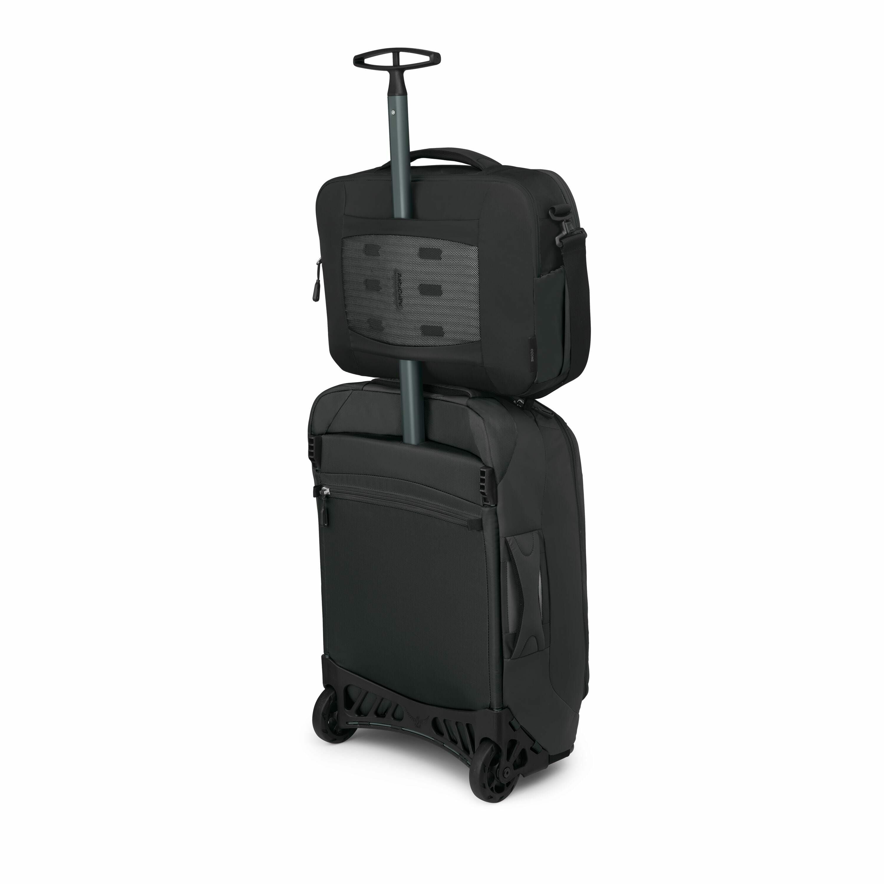 The image depicts a black, hard-shell carry-on suitcase with a retractable handle. Sitting on top of the suitcase, secured by the handle, is a smaller black travel bag with multiple compartments, likely designed for easy access to essential items. The sui