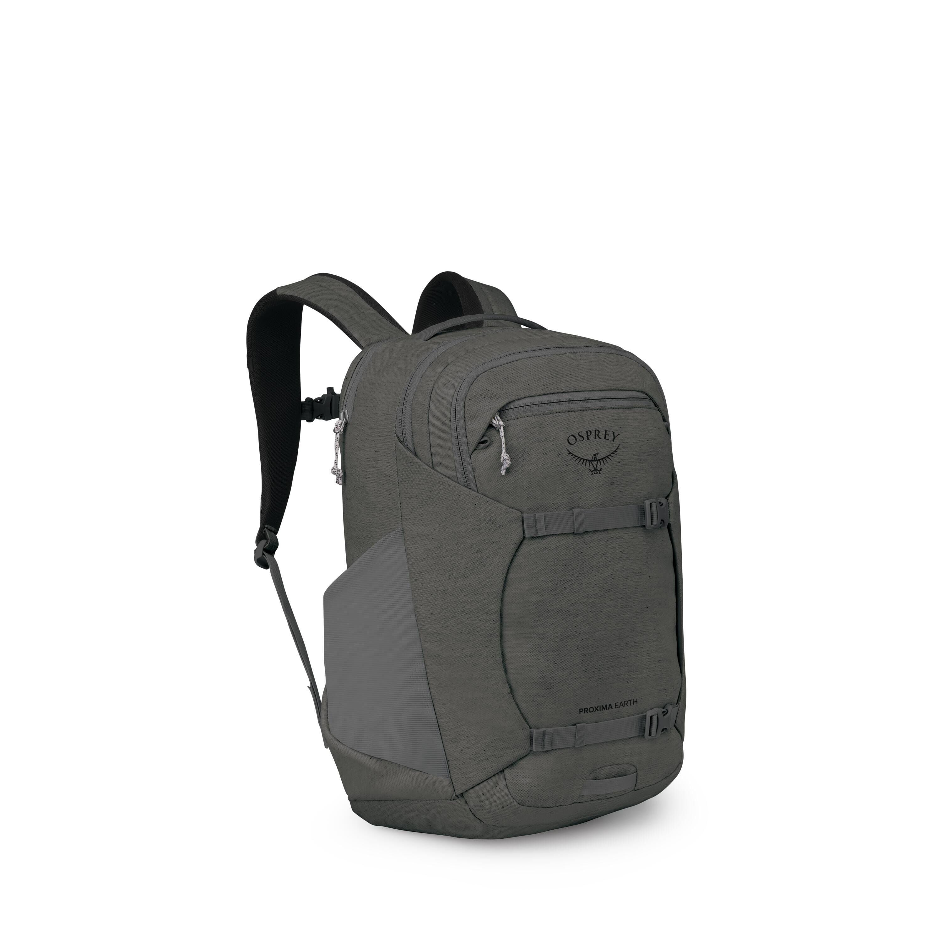 A sleek, dark gray Osprey backpack is shown from a front-left angle on a white background. It features multiple zippered compartments, a front shove-it pocket secured by horizontal compression straps, and stretch side pockets. The shoulder straps are padd