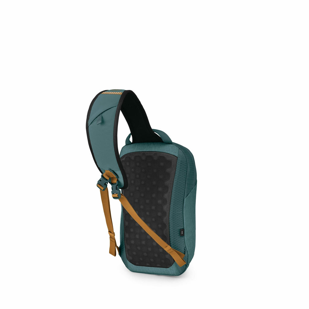 The image showcases a sling-style backpack with a distinct color scheme and design. The backpack is primarily teal with a textured appearance, complemented by brown straps and accents that add a contrasting touch. The back panel of the backpack features a