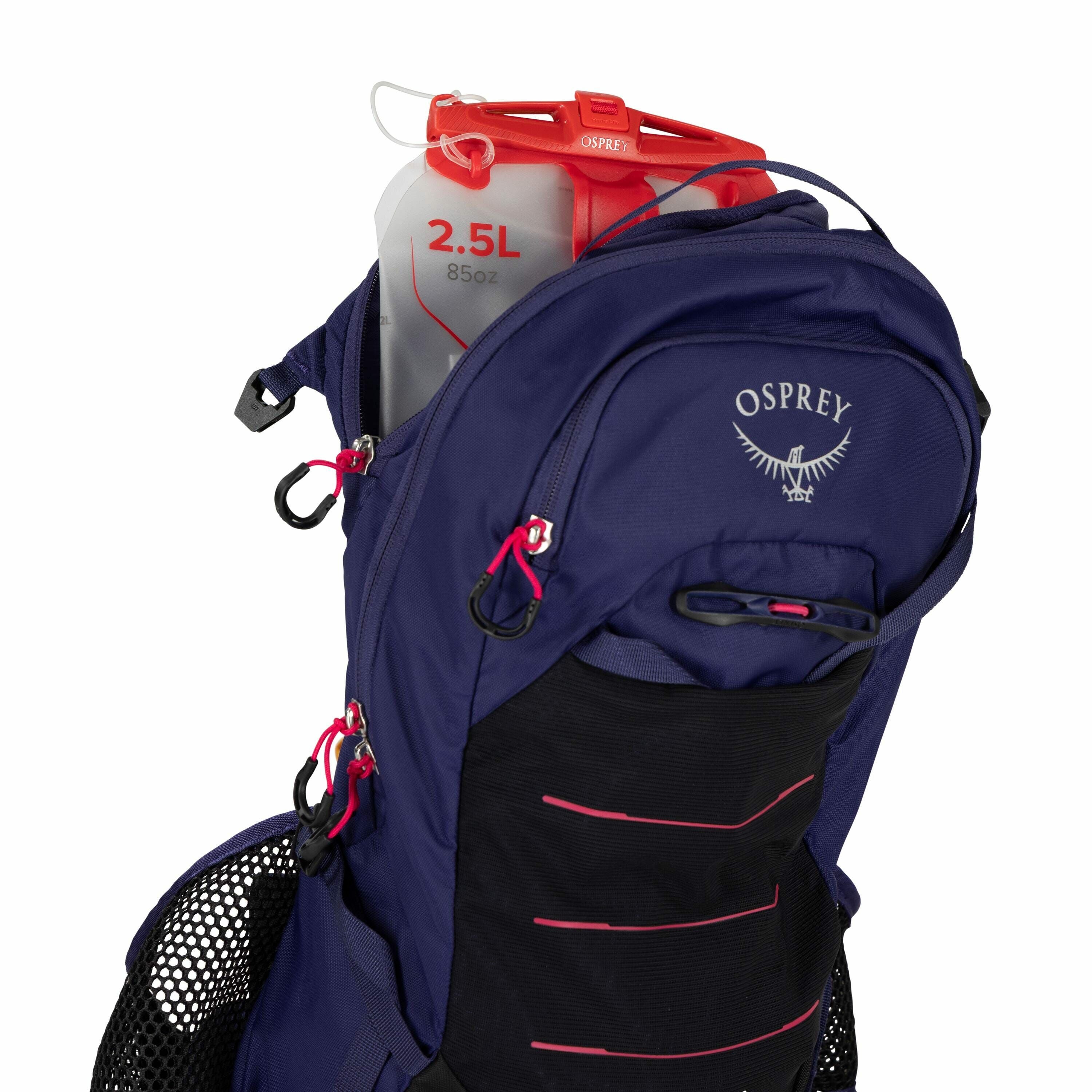 The image shows a close-up view of a blue Osprey backpack with a focus on its hydration system. Inside the partially open top compartment, a transparent hydration reservoir is visible, which is marked with a red measurement indicating a 2.5-liter (85 oz)