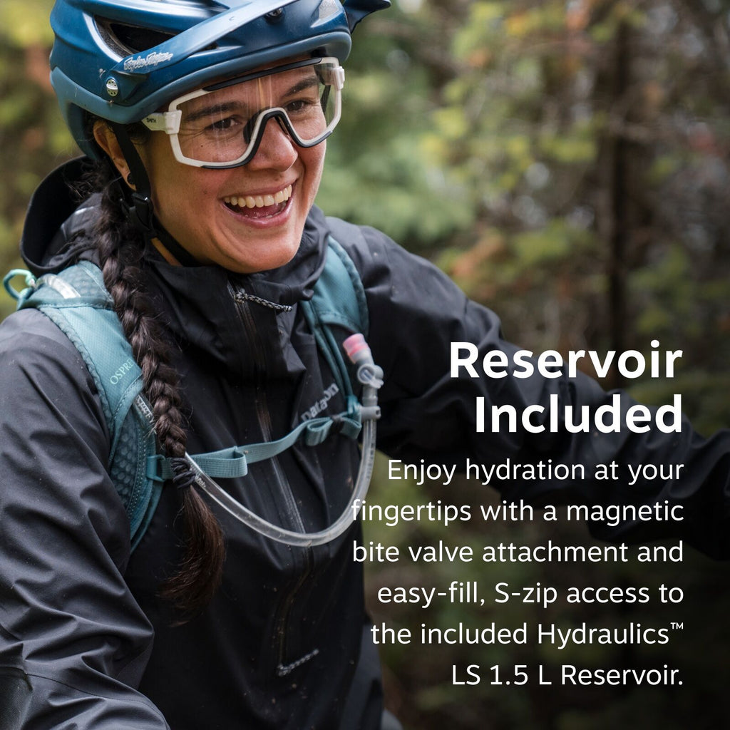 The image shows a person wearing outdoor gear, including a blue helmet and a black jacket, with a teal hydration backpack strapped on. The backpack features Osprey branding and includes a hydration system with a visible hose leading to the front of the ja