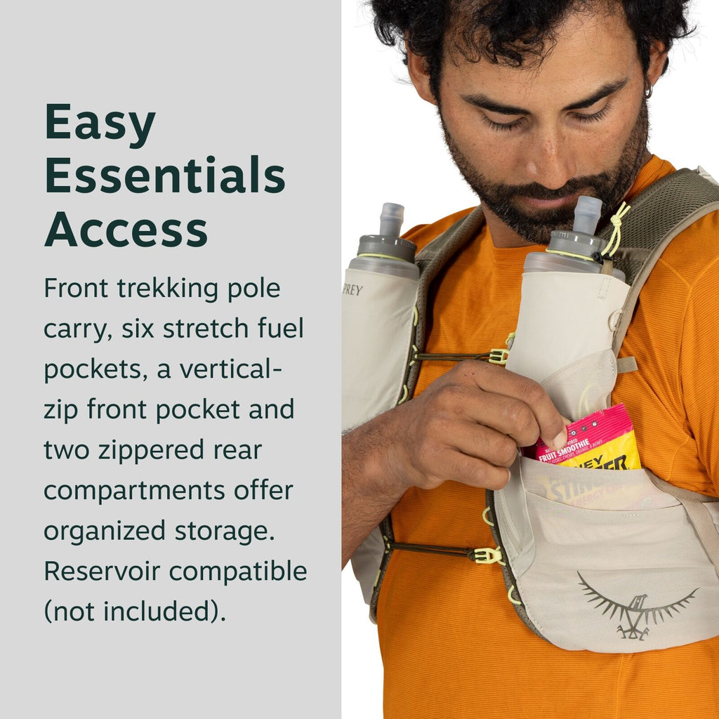 The image features a person wearing a specialized hydration vest designed for outdoor activities like trekking or running. The vest includes multiple storage compartments: two water bottles are visible in front pockets, and the person is holding a packet
