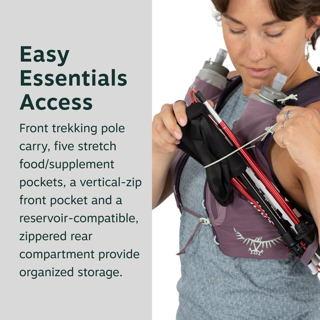 The image shows a person wearing an outdoor hydration vest designed for easy access to essentials during trekking. The vest is a muted purple color and features a logo that resembles an abstract bird with outstretched wings. It includes a front trekking p