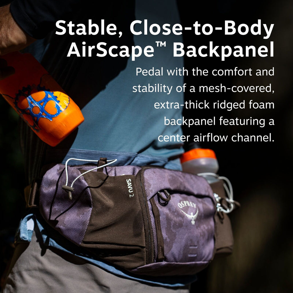 The image features a person wearing a blue top and grey pants with a waist pack branded as Osprey. The pack is labeled "SAVU 2" and has two compartments, with a zipper and visible pull tab. An orange water bottle with blue designs is inserted into one of