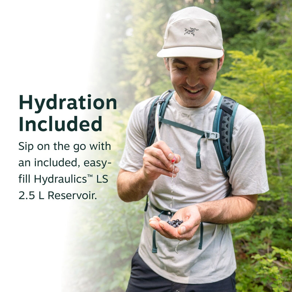 The image features an outdoor scene with a person standing in a lush green forest, wearing a light gray T-shirt and a gray backpack. They are holding a handful of dark berries in one hand, with water dripping from the other hand as if they are rinsing the