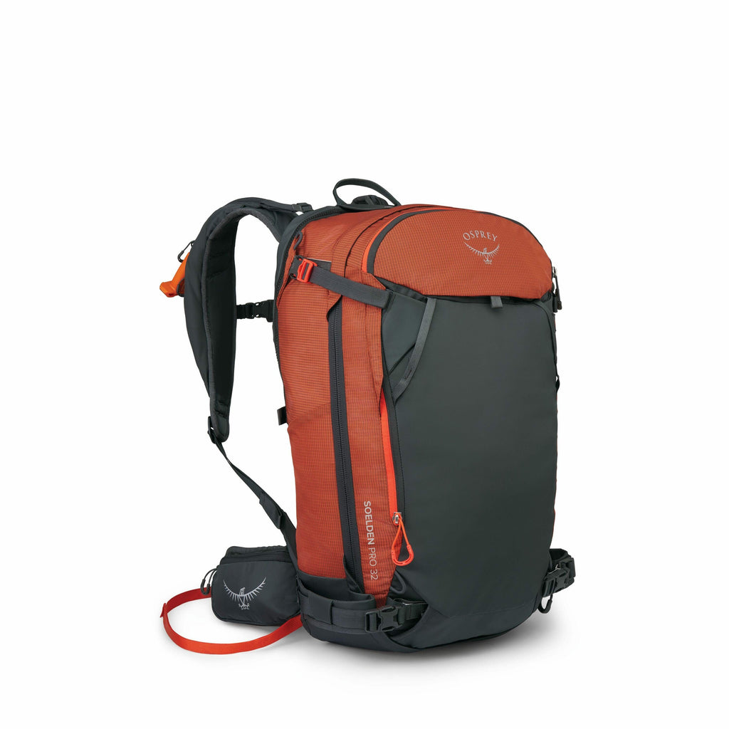 The image shows an Osprey backpack with a combination of dark gray and orange colors. The main body of the backpack is predominantly dark gray, while the top section and the zipper accents are a bright orange. The backpack has a robust design, featuring p