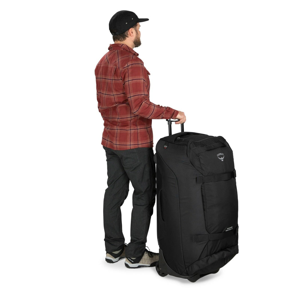 a person modeling the Sojourn™ Shuttle Wheeled Duffel 36"/130L in color Black