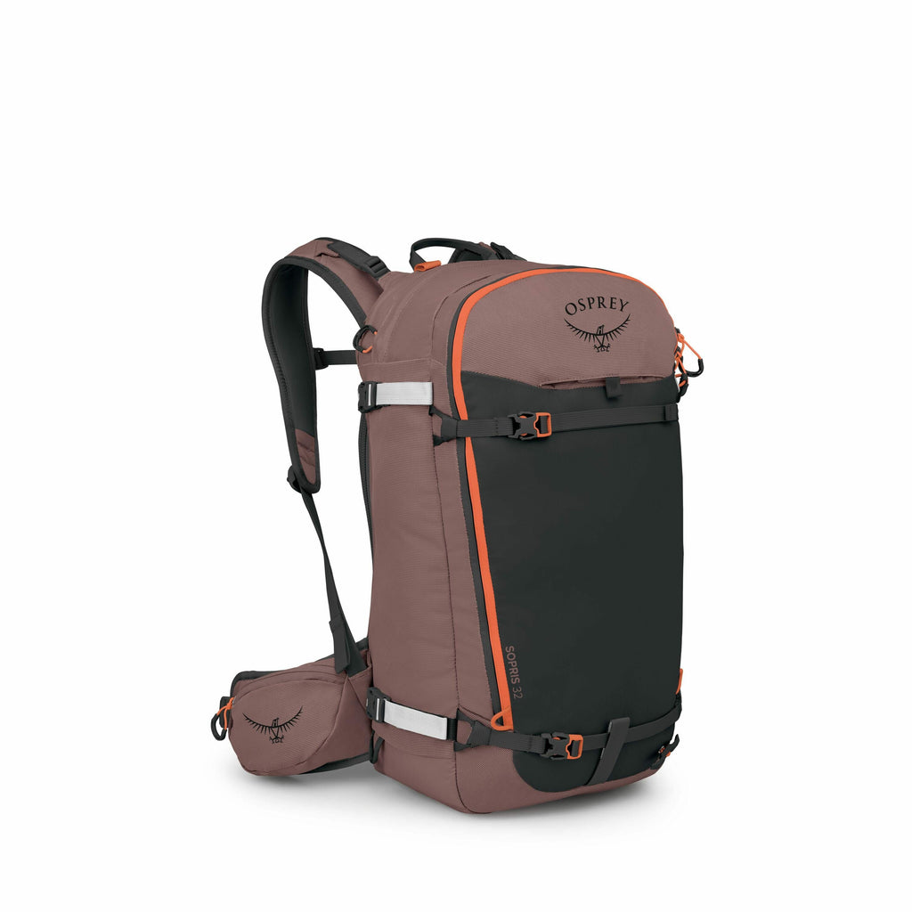 The image showcases a backpack from the brand Osprey, specifically the Soelden 32 model. It features a predominantly brown color with a large black front panel that includes a bright orange outline for contrast. The backpack has padded shoulder straps and