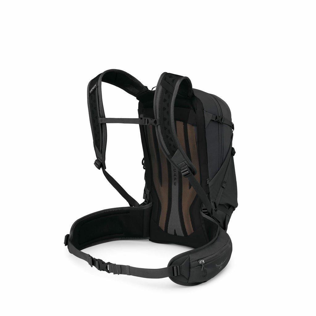 The image depicts a black backpack with detailed features visible from an angled rear view. The backpack showcases padded shoulder straps, an adjustable sternum strap, and a padded hip belt, designed for comfort and support during extended use. The back p