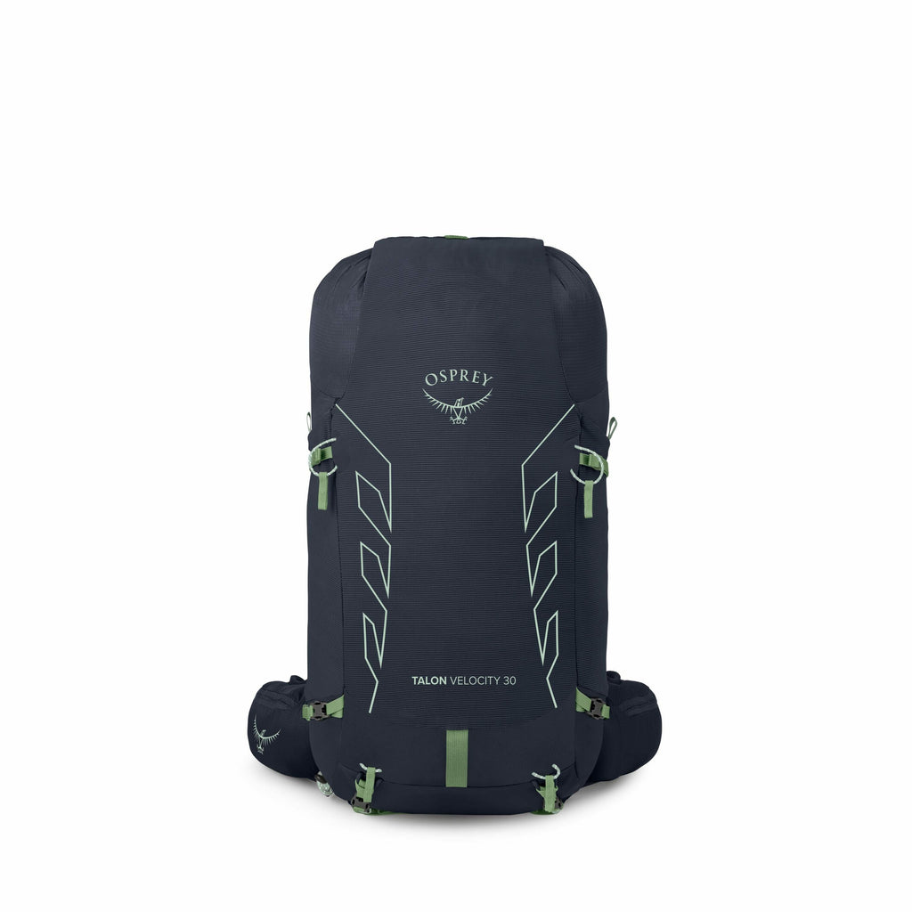 The image showcases an Osprey Talon Velocity 30 backpack, designed for outdoor and adventure use. The backpack is primarily navy blue with subtle light green accents, including the Osprey logo and text that reads "TALON VELOCITY 30" on the front. Its stre